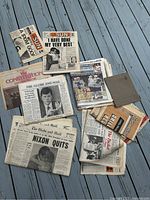 Top view of vintage newspapers stack including The Globe and Mail, Sun, Kennedy and other sections from 1974.