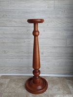 Full front view of the pine plant stand showing top, column and base