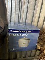 Closed box showing Durabrand Rice Cooker with white appliance image and branding.