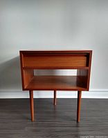 Front view of nightstand showing drawer and open shelf