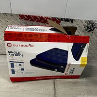 Boxed pack of two Outbound single twin air beds, front showing product image and details.