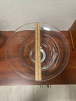 Top view of clear glass bowl with ruler measuring about 12 inches across the diameter.