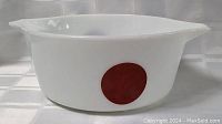 Side angle showing white Pyrex casserole dish with red dot and pouring spout.