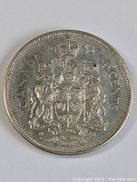 Front of the 1965 Canadian 50 Cent Coin showing full coat of arms and inscriptions