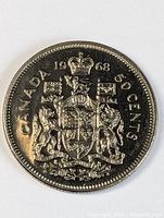 Close-up photo of the front face of the 1968 Canadian fifty cent coin showing Canadian coat of arms and inscriptions.