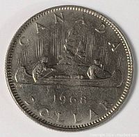 Obverse side of 1968 Canadian one dollar coin showing Voyageur design with two men paddling a canoe and 'CANADA DOLLAR 1968' inscribed.