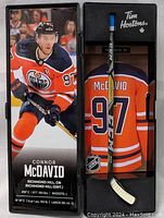 Front view of the collector mini hockey stick in the box featuring Connor McDavid in full Edmonton Oilers uniform, number 97, displaying Tim Hortons branding.