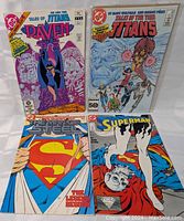 All four vintage DC Comics comic books arranged in a row showing their colorful covers.