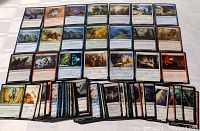 Full lot of Magic: The Gathering cards laid out showing multiple rows and columns with clear artwork and colored borders.