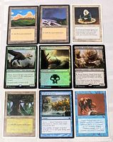 9 Magic The Gathering cards arranged in 3 rows, including plains, swamp, forest lands, and legendary creature cards