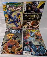 All four Marvel comic books shown together, covers visible.