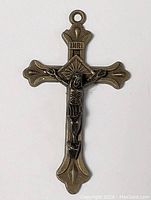 Front view of the antique-style metal cross pendant featuring a Jesus figure and INRI inscription.