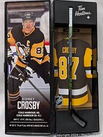 Mini Sidney Crosby hockey stick in display packaging showing player image, stats, and branding.