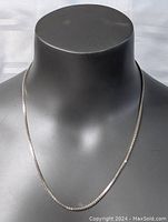 Full view of the sterling silver chain necklace displayed on a black mannequin bust.