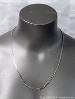 Sterling silver necklace chain displayed on black mannequin bust, showing chain length and style.
