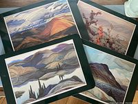 Four placemats laid out showing different Franklin Carmichael Group of Seven prints with cork backing.