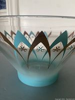 Close-up of the blue and gold atomic pattern around the bowl showing detail and wear