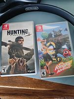 Two Nintendo Switch game cases for Ring Fit Adventure and Hunting Simulator shown together with covers visible.