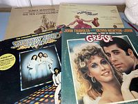 Lot of four soundtrack records featuring Grease, Saturday Night Fever, The Ten Commandments, and The Sound of Music.