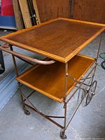 Full view of cart upright showing two oak shelves and metal folding frame