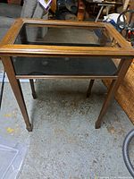Front view of oak-framed display case on concrete floor