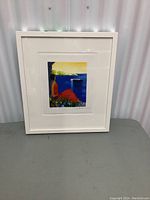 Full view of the artwork in white frame, showing colors and overall condition.