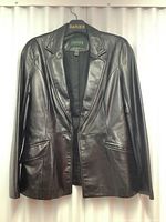 Full view of the vintage ladies Danier black genuine leather jacket hanging on Danier branded hanger against white background.