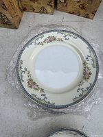 Top-down view of one vintage ceramic bread plate showing floral and scrollwork decorative pattern.