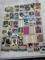Overview of approximately 45+ vintage baseball cards from various MLB teams, laid out on a flat surface.
