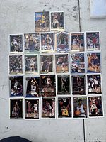 Photo showing a layout of 33 basketball cards showing various players from NBA teams in different action and portrait shots.