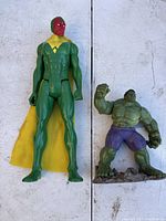 Vision and Hulk full view posed standing on flat surface.