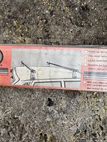 Close-up photo of Load Master roof bars box with illustration and features