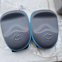 Two closed hard shell snorkel mask cases side by side, black color with blue trim and Wildhorn logo on top.