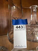 Photo showing twisted clear glass pitcher and part of decanter with stopper