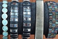 All five bracelets arranged horizontally showing the turquoise bracelet, three striped bangles, and the metal bangle