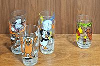 Group photo of six vintage collectible character glasses including Pepsi Bullwinkle, Rocky, Chilly Willy, Casper, Underdog, and Sears Winnie The Pooh juice glass
