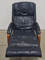 Front view of a black leather Lazy Boy recliner showing padded seat, backrest, armrests and footrest.