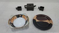 Full lot overview showing Yixing teapot set, Noritake bowl, and brown stoneware plate