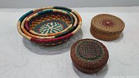 Top view showing 3 colorful nesting baskets alongside 2 lidded Chinese sewing baskets