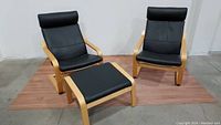 Two POÄNG armchairs plus matching footstool on laminate floor