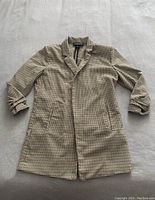 Front view of the Rachel Zoe blazer laid flat, showing the houndstooth pattern, notched collar, and front pockets.