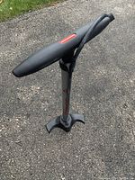 Photo of Schwinn bike tire pump showing the handle and base, highlighting its condition and branding.
