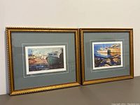 Pair of two framed Christopher Gorey prints, showing matching wood frames with gold finish and double grey/white matting.