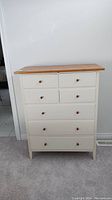 Front view showing two small top drawers, two smaller middle drawers, and three larger bottom drawers beneath solid pine top