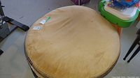 View of the 40 inch round beige Kirkland dog bed showing the top cushion surface with visible dirt and stains.