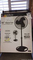 Front view of the Lasko 16-inch stand fan box showing product features including adjustable height and three speeds.