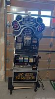 Full front view of slot machine showing marquee, reel display, control panel and coin tray
