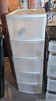 Full view of the 5-drawer plastic storage container, showing the stacked drawers and white frame.