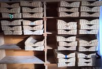 Full view of multiple wicker basket trays arranged on wooden shelving units