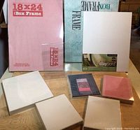 Multiple new and used box frames in packaging with a clayboard for artists visible, assorted sizes.